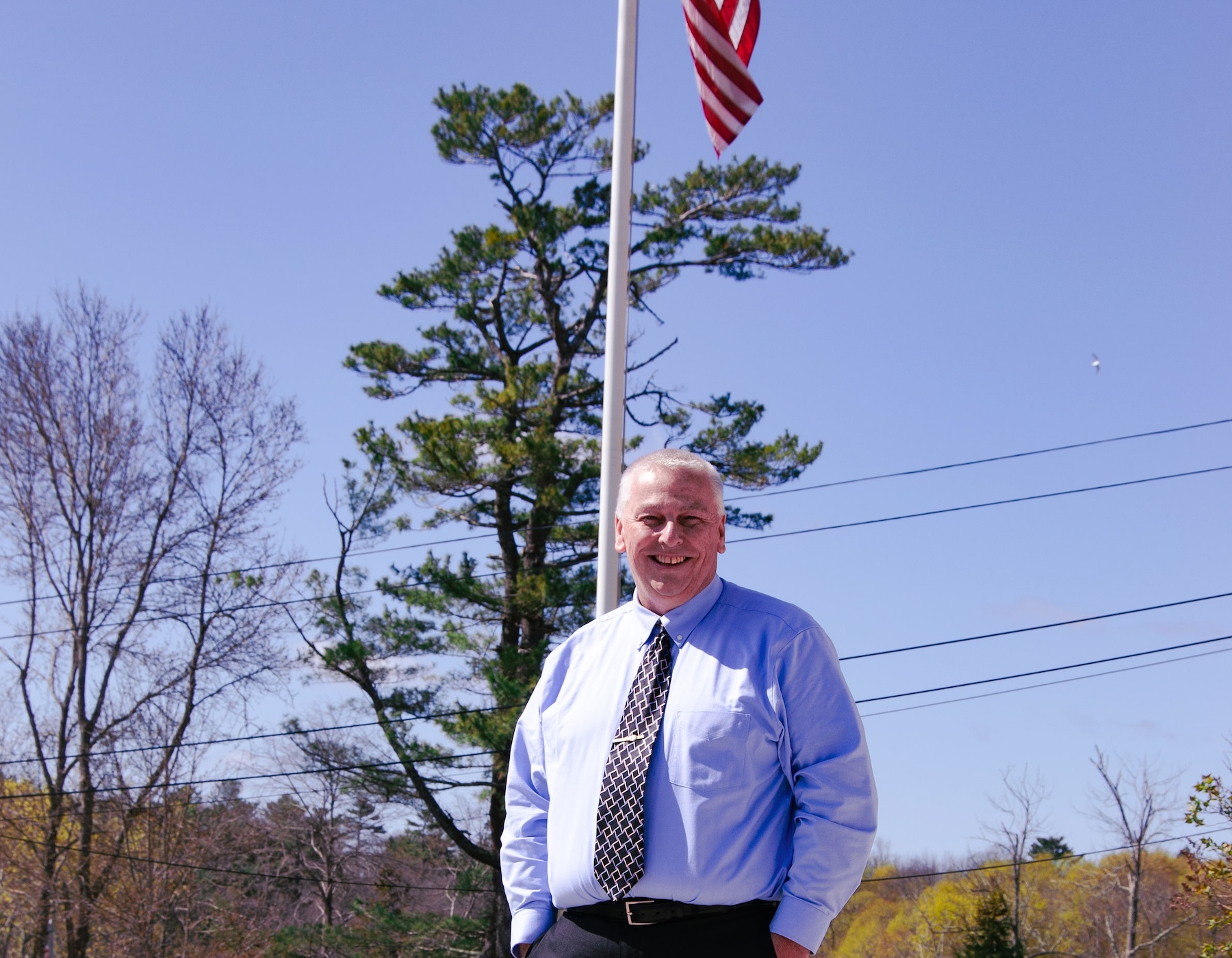 corey standing in front of flag